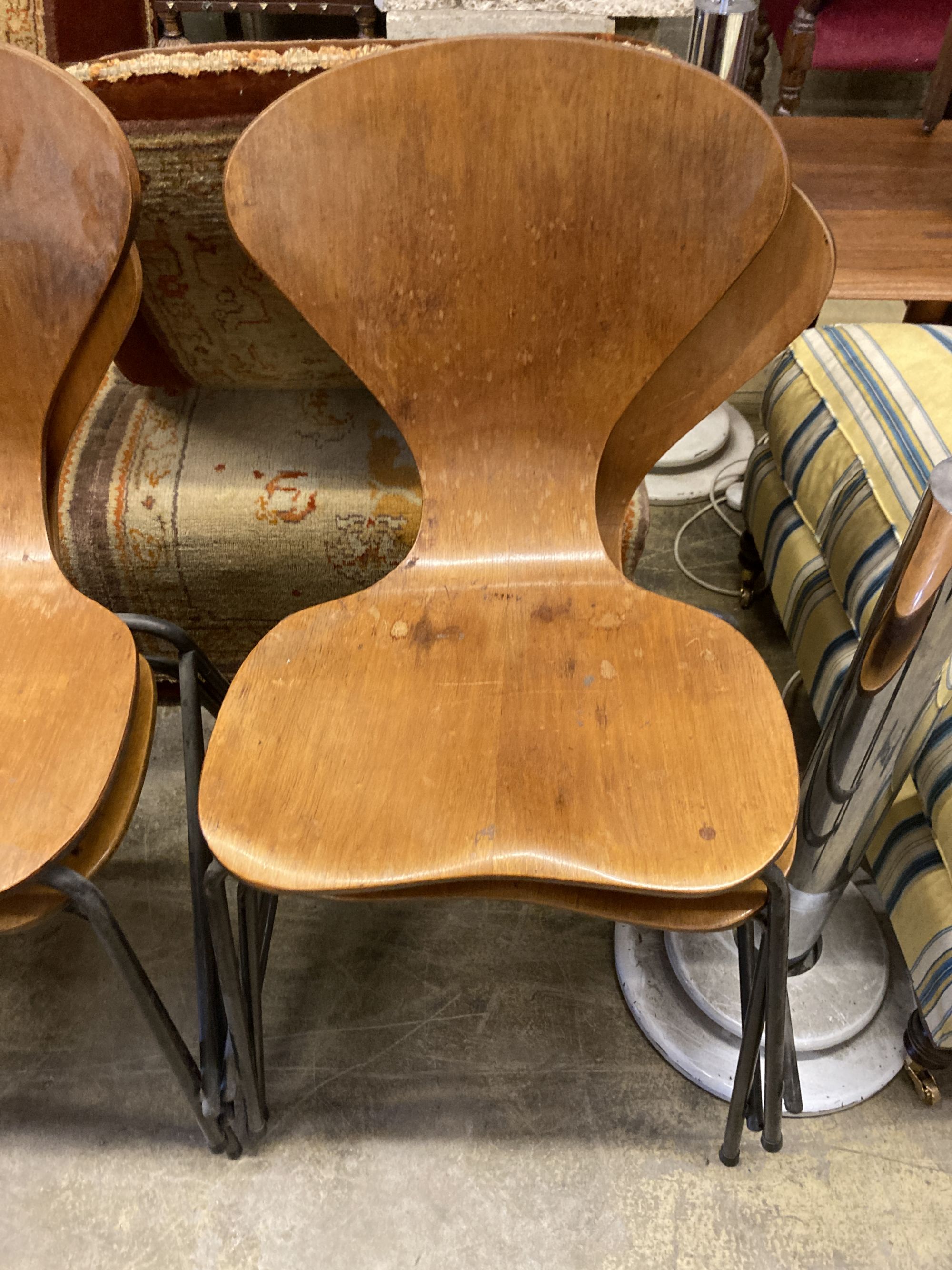 A set of four Jacobsen style bent-ply and tubular metal stacking dining chairs, width 44cm, depth 42cm, height 86cm